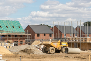Construction industry building site. Houses at various stages of completion.